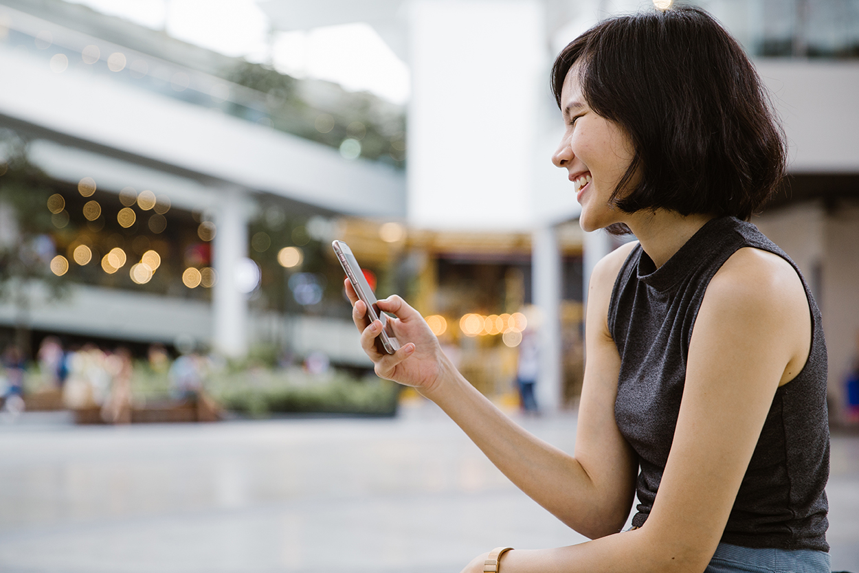 Young woman laughing with phone Young woman laughing with phone