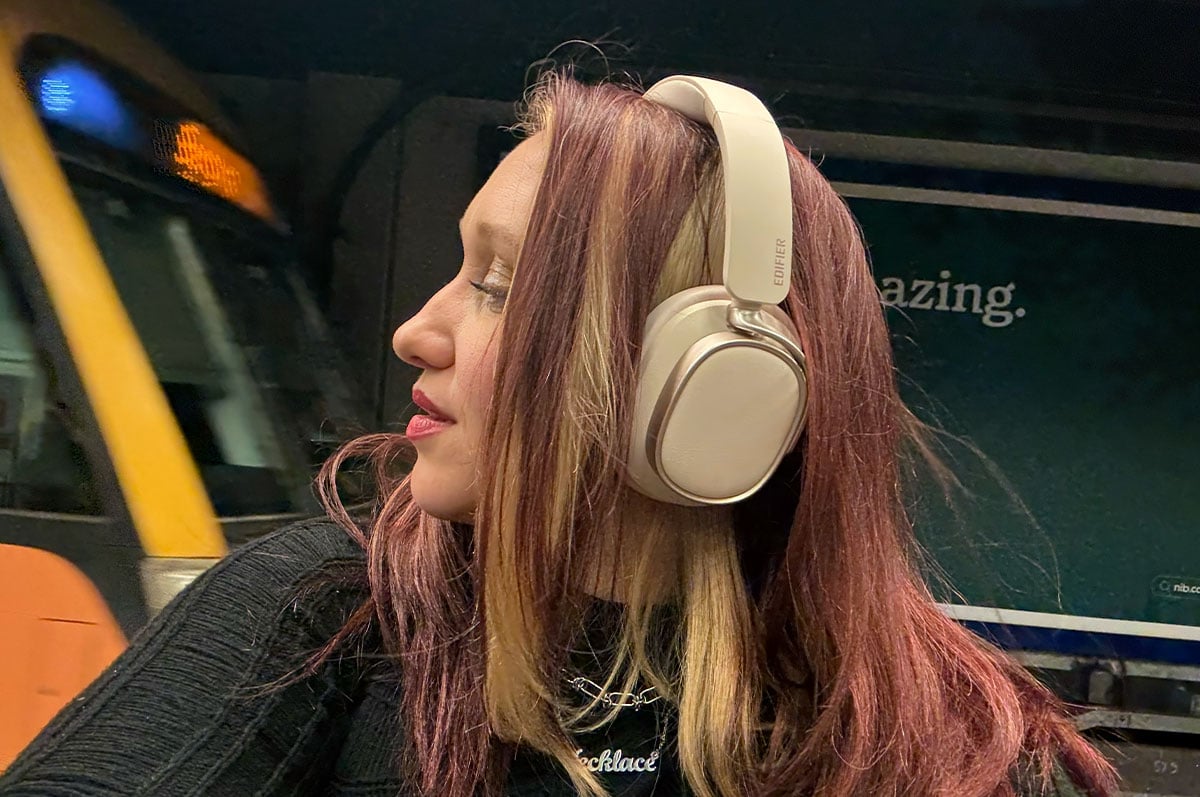 woman's profile wearing headphones with a train in the background woman's profile wearing headphones with a train in the background