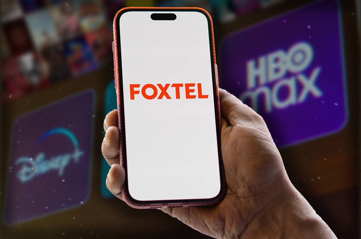 Foxtel logo on a smartphone with alternate streaming services in the background Foxtel logo on a smartphone with alternate streaming services in the background