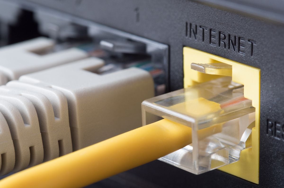 Yellow cable plugging into Internet port on a modem Yellow cable plugging into Internet port on a modem