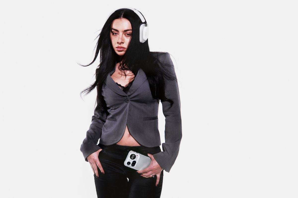 Nothing's new ambassador Charli XCX wearing Nothing headphones and holding a Nothing phone Nothing's new ambassador Charli XCX wearing Nothing headphones and holding a Nothing phone