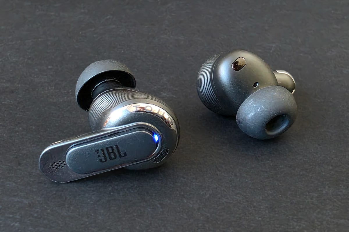 JBL Tour Pro 3 earbuds on a table JBL Tour Pro 3 earbuds on a table